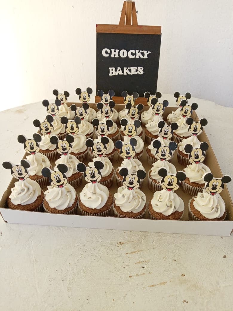 Close view of piped white frosting on cupcakes.